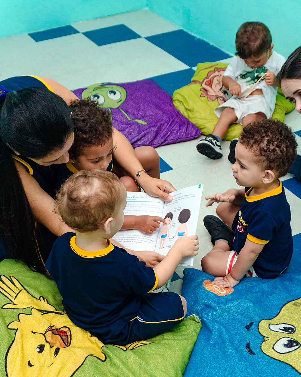 Professora e crianças em momento devocional no Colégio Campos Piaget